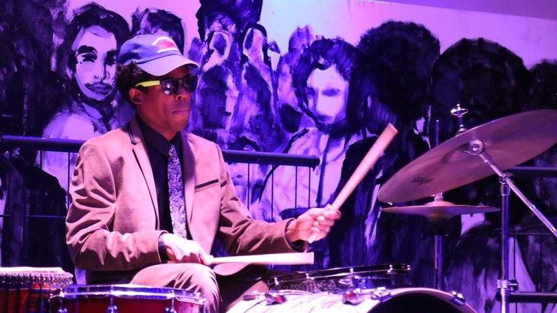 Singer on stage accompanied by piano.