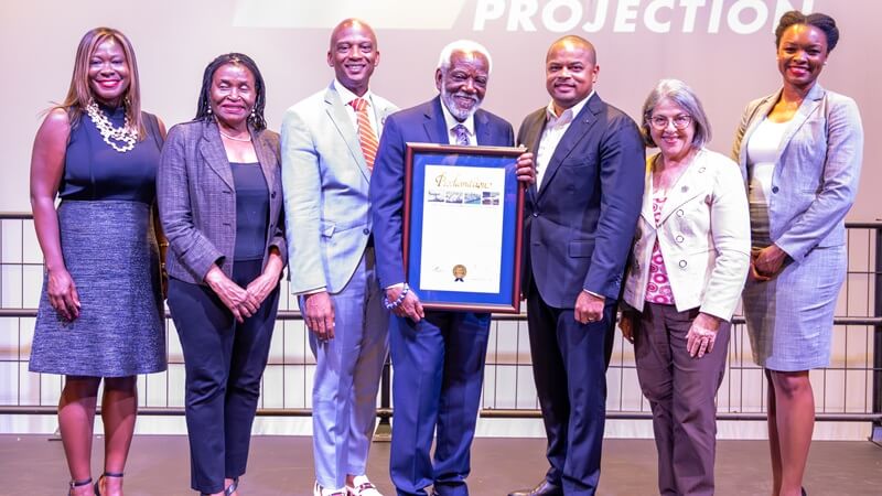 Marshall L. Davis posing with Mayor Daniella Levine Cava and other elected officials